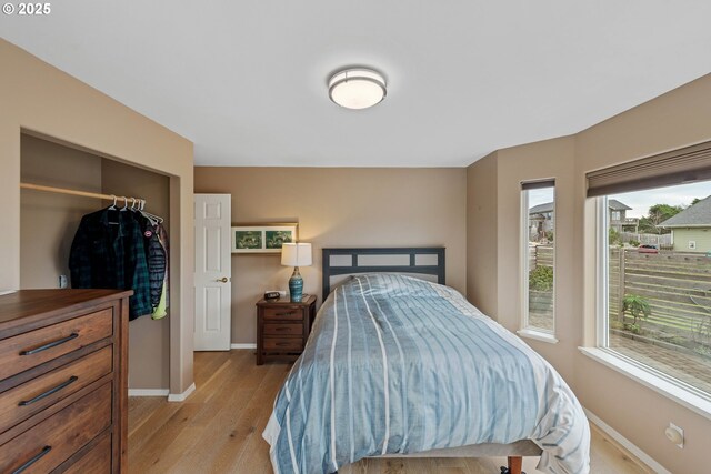 bedroom featuring light wood-type flooring and a closet