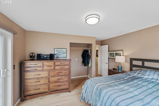 bedroom with light hardwood / wood-style flooring and a closet