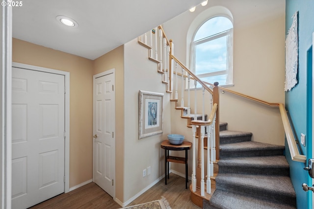 stairs with hardwood / wood-style flooring