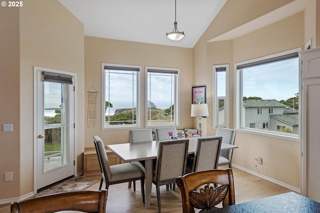 dining area featuring light hardwood / wood-style floors and lofted ceiling