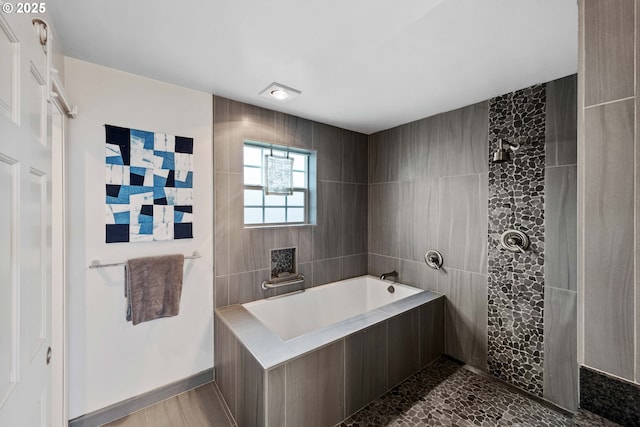 bathroom featuring tiled bath