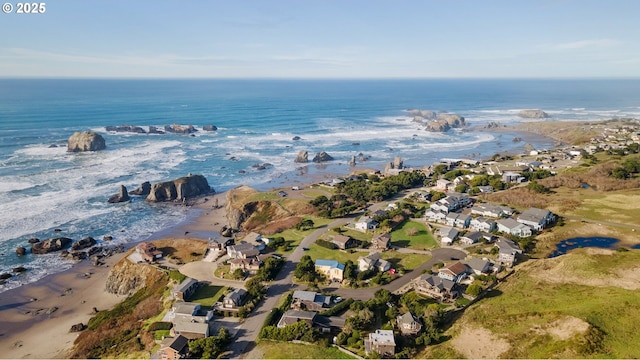 drone / aerial view featuring a water view and a view of the beach