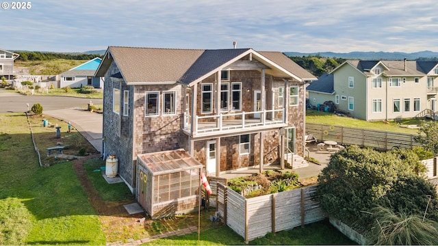 rear view of property with a balcony