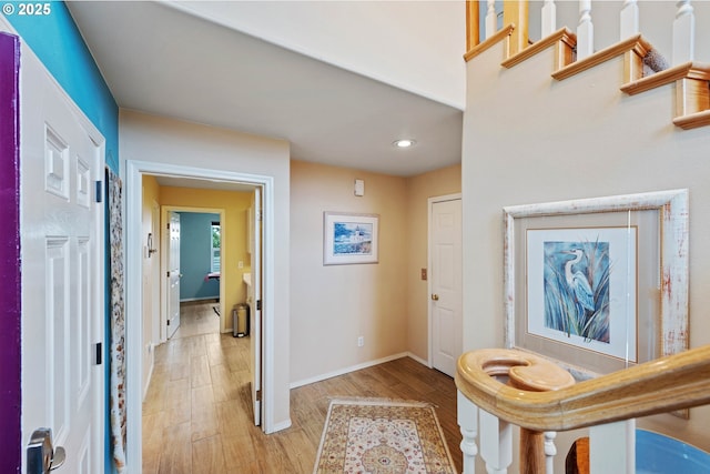 hallway with light hardwood / wood-style floors