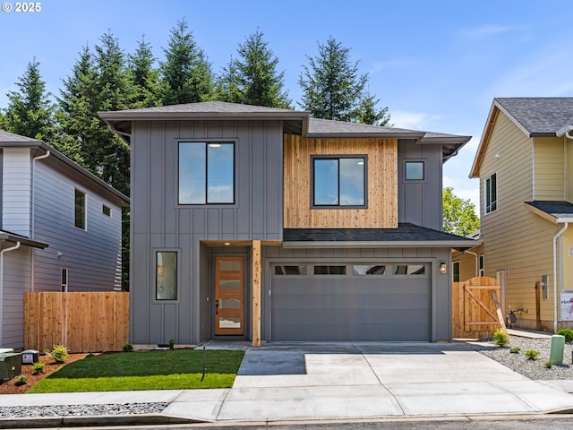 6715 NE 132nd St, Vancouver, WA 98686 - contemporary home with board and batten siding, an attached garage, driveway, a shingled roof, and a gate