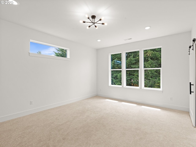 6715 NE 132nd St, Vancouver, WA 98686 - carpeted spare room featuring healthy amount of natural light, a chandelier, baseboards, recessed lighting, and a barn door