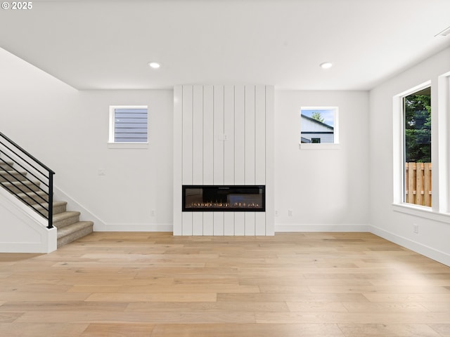 6715 NE 132nd St, Vancouver, WA 98686 - unfurnished living room featuring stairway, light wood-style floors, a large fireplace, baseboards, and recessed lighting