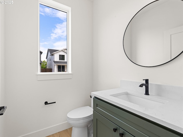 6715 NE 132nd St, Vancouver, WA 98686 - half bathroom featuring vanity, baseboards, toilet, and wood finished floors