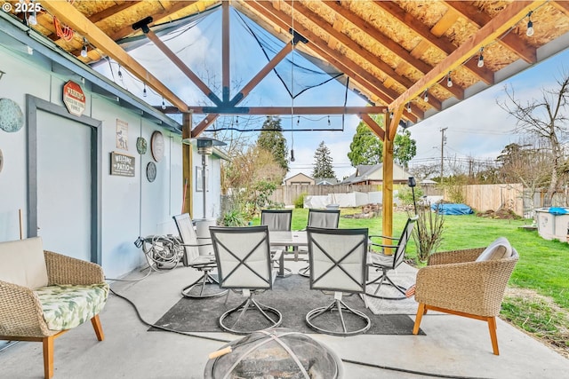 view of patio featuring outdoor dining space and fence