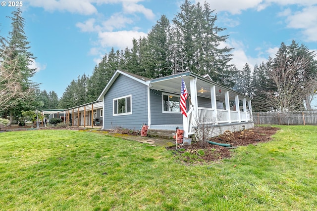 view of property exterior featuring a lawn and fence