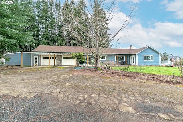 single story home featuring a garage and driveway