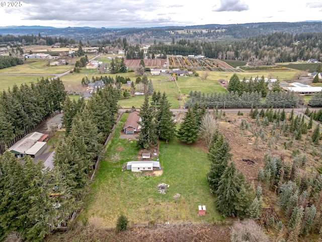 drone / aerial view with a wooded view