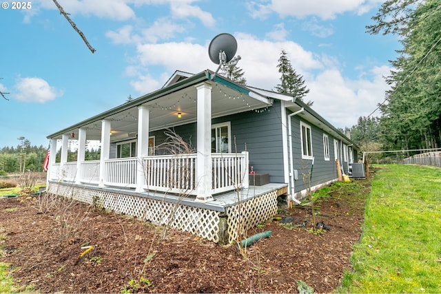 rear view of property featuring a porch and central AC