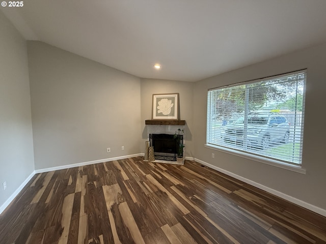 18294 SW Bergs Ct, Beaverton, OR 97003 - unfurnished living room featuring healthy amount of natural light, dark wood-style flooring, a fireplace, and recessed lighting