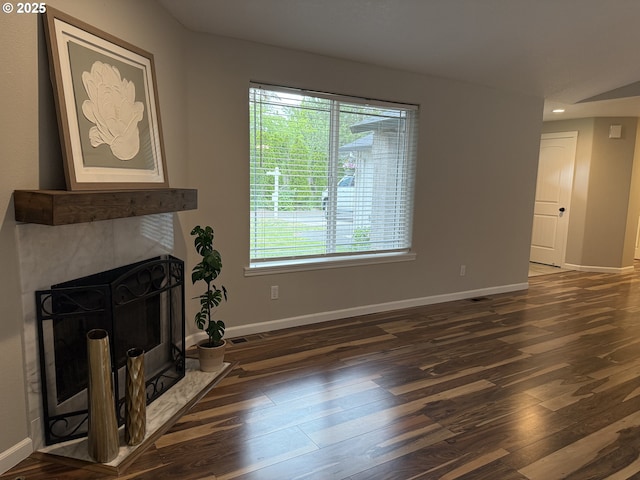 18294 SW Bergs Ct, Beaverton, OR 97003 - unfurnished living room with wood finished floors, baseboards, a tiled fireplace, healthy amount of natural light, and recessed lighting