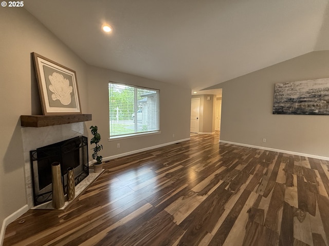 18294 SW Bergs Ct, Beaverton, OR 97003 - unfurnished living room with wood finished floors, vaulted ceiling, baseboards, a fireplace, and recessed lighting