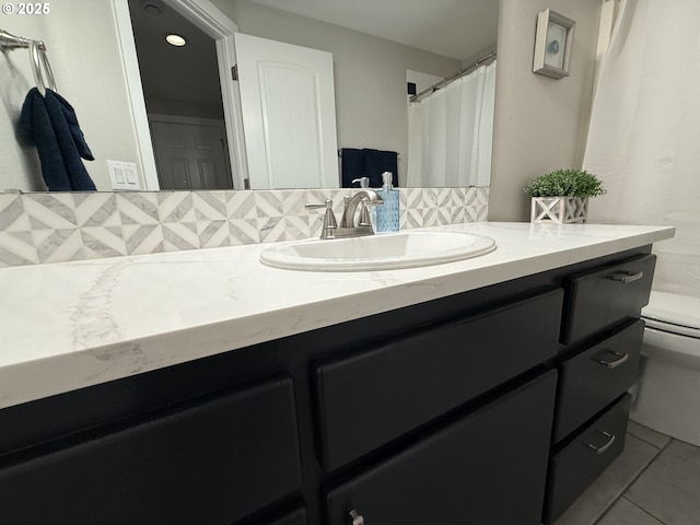 18294 SW Bergs Ct, Beaverton, OR 97003 - full bathroom with toilet, vanity, backsplash, and tile patterned flooring