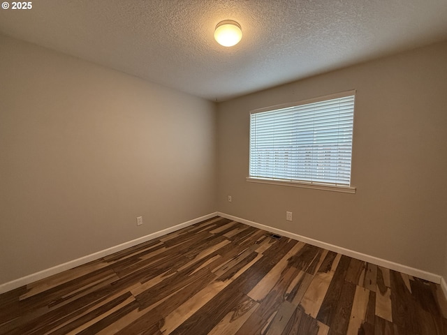 18294 SW Bergs Ct, Beaverton, OR 97003 - unfurnished room with dark wood-style floors, a textured ceiling, and baseboards