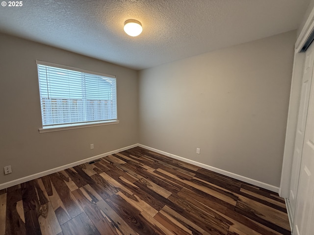 18294 SW Bergs Ct, Beaverton, OR 97003 - spare room with dark wood-style flooring, a textured ceiling, and baseboards
