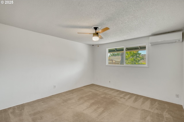 carpeted empty room with a wall mounted AC, ceiling fan, and a textured ceiling