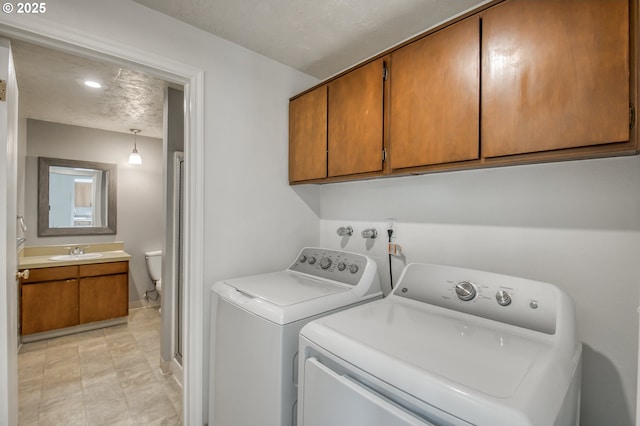 washroom featuring separate washer and dryer and cabinet space