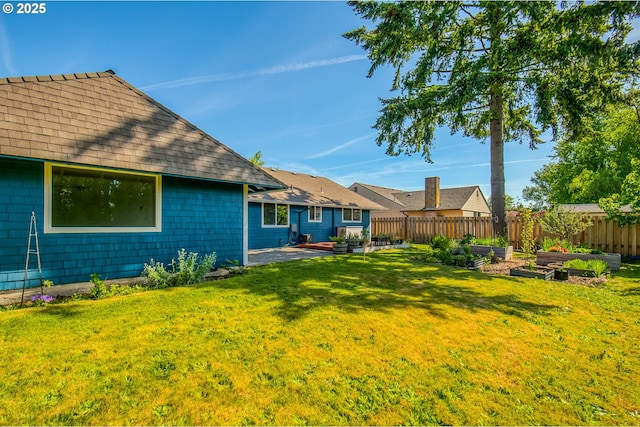 view of yard with a vegetable garden and a patio