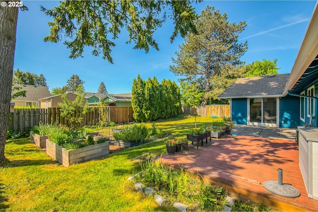view of yard featuring a garden and a wooden deck