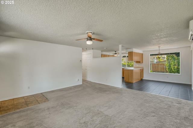 unfurnished living room with dark tile patterned flooring, a ceiling fan, dark colored carpet, baseboards, and a textured ceiling