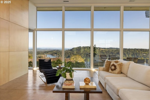 sunroom / solarium featuring a water view and plenty of natural light