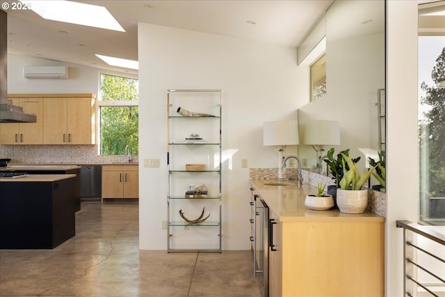 kitchen with finished concrete flooring, light brown cabinetry, tasteful backsplash, a sink, and a skylight