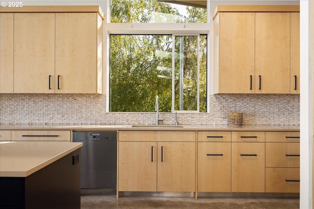 kitchen with light brown cabinets, light countertops, tasteful backsplash, a sink, and dishwasher