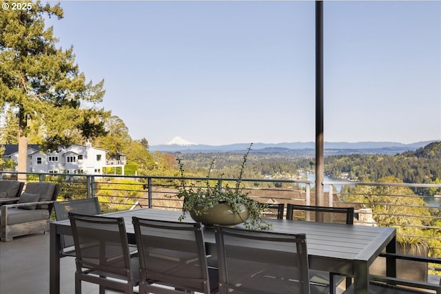 balcony with a mountain view and outdoor dining space