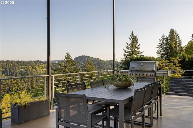 exterior space with grilling area and a forest view