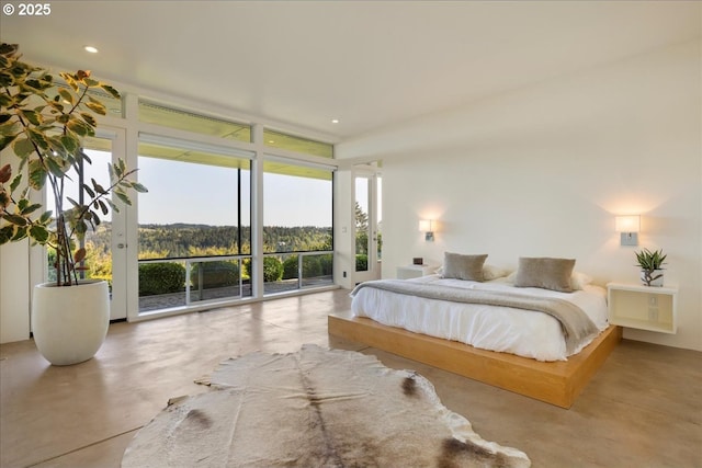 bedroom featuring access to outside, finished concrete floors, and expansive windows
