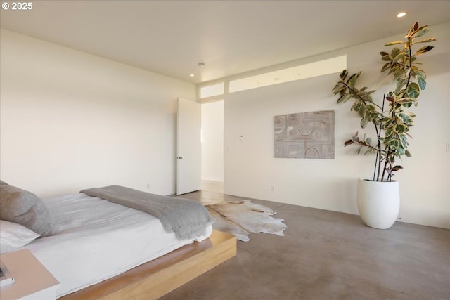 bedroom with recessed lighting and concrete floors