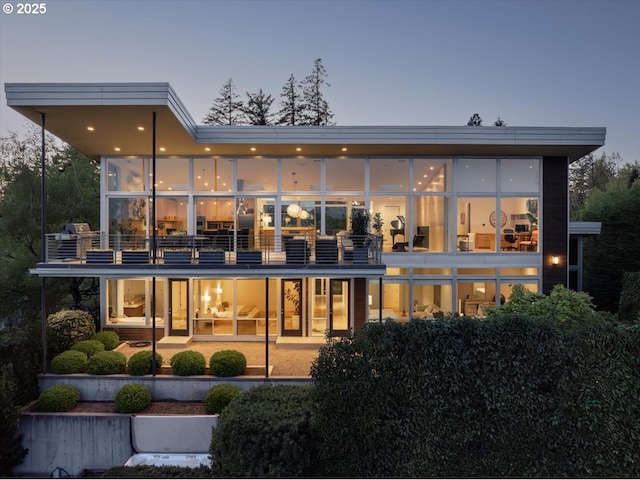 back of property with a balcony