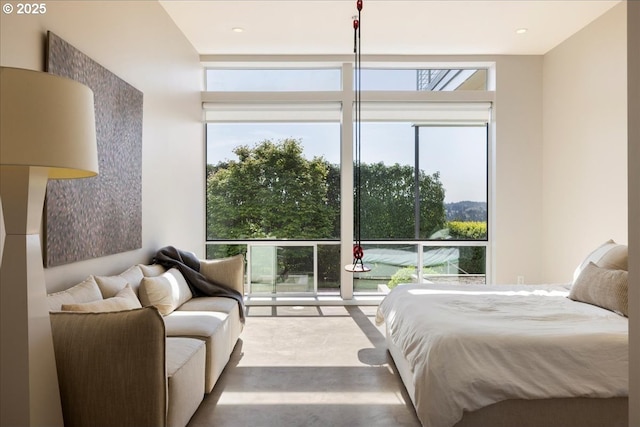 carpeted bedroom featuring access to outside and a wall of windows