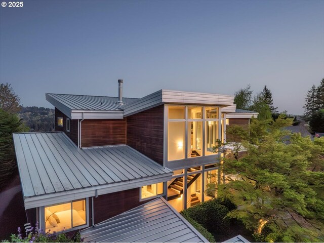 1900 Crest Dr, Lake Oswego, OR 97034 - rear view of house featuring a standing seam roof, metal roof, and a sunroom