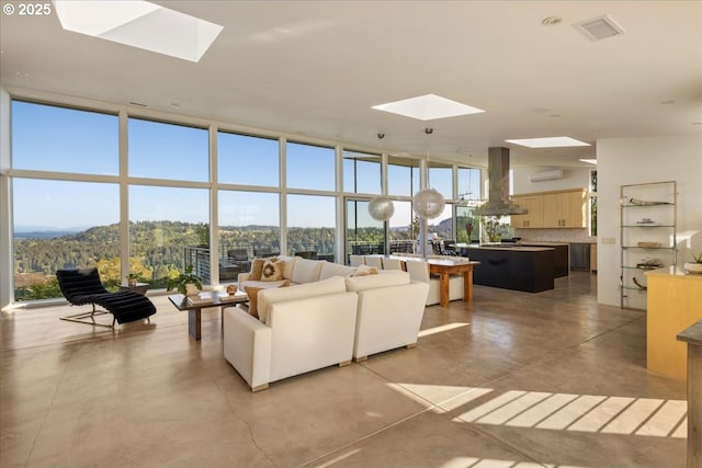 living room featuring a skylight, floor to ceiling windows, and visible vents