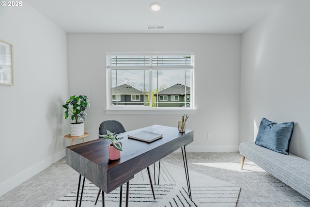office area featuring carpet, visible vents, and baseboards