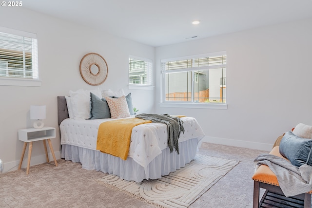 carpeted bedroom featuring baseboards, visible vents, and recessed lighting