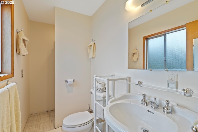3621 NE 10th St, Otis, OR 97368 - bathroom featuring toilet, tile patterned floors, and a sink