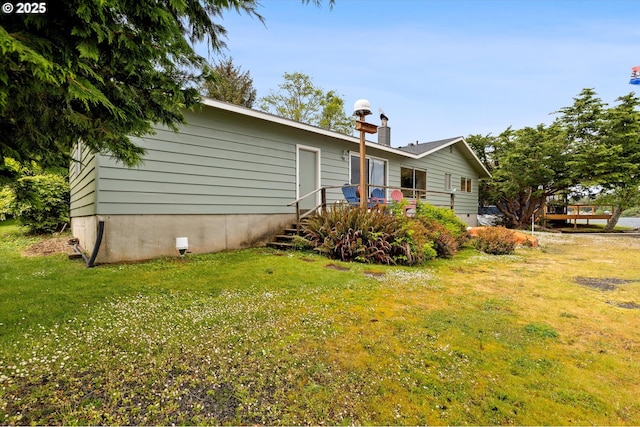 3621 NE 10th St, Otis, OR 97368 - view of property exterior with a yard and a wooden deck