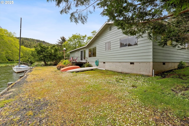 3621 NE 10th St, Otis, OR 97368 - back of house with crawl space, a water view, and a lawn