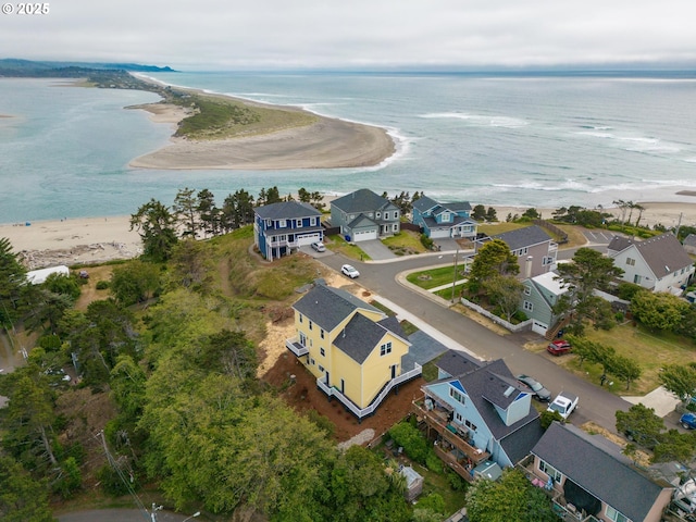 birds eye view of property featuring a beach view and a water view