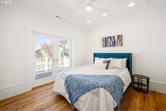 bedroom featuring wood finished floors, french doors, access to exterior, visible vents, and recessed lighting