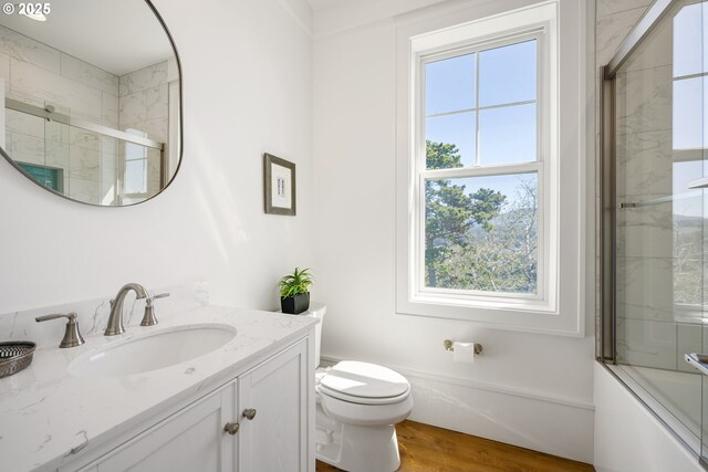 full bath featuring wood finished floors, toilet, and vanity