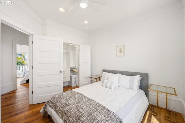 bedroom featuring recessed lighting, wood finished floors, and a closet