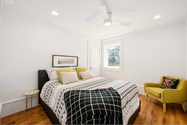 bedroom featuring a ceiling fan, wood finished floors, and recessed lighting