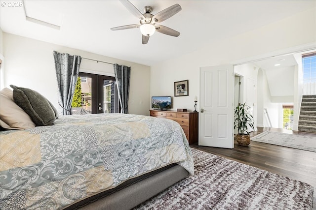 bedroom featuring access to outside, french doors, multiple windows, and wood finished floors